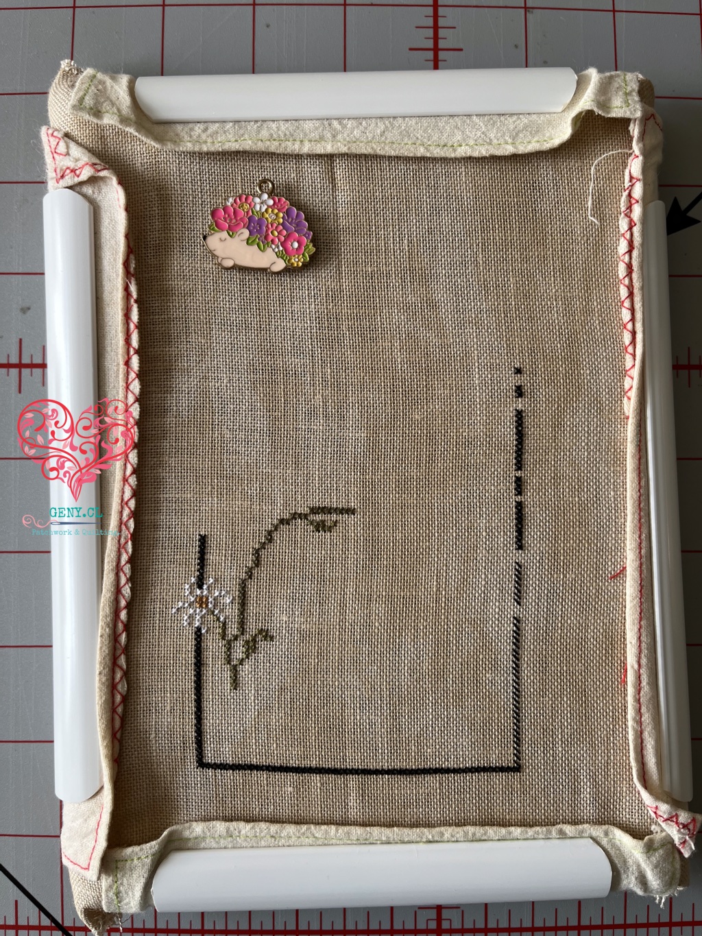 Primeras puntadas del bordado Hedgehog Row de Plum Street Samplers, con parte del borde del diseño trabajado en punto de cruz.